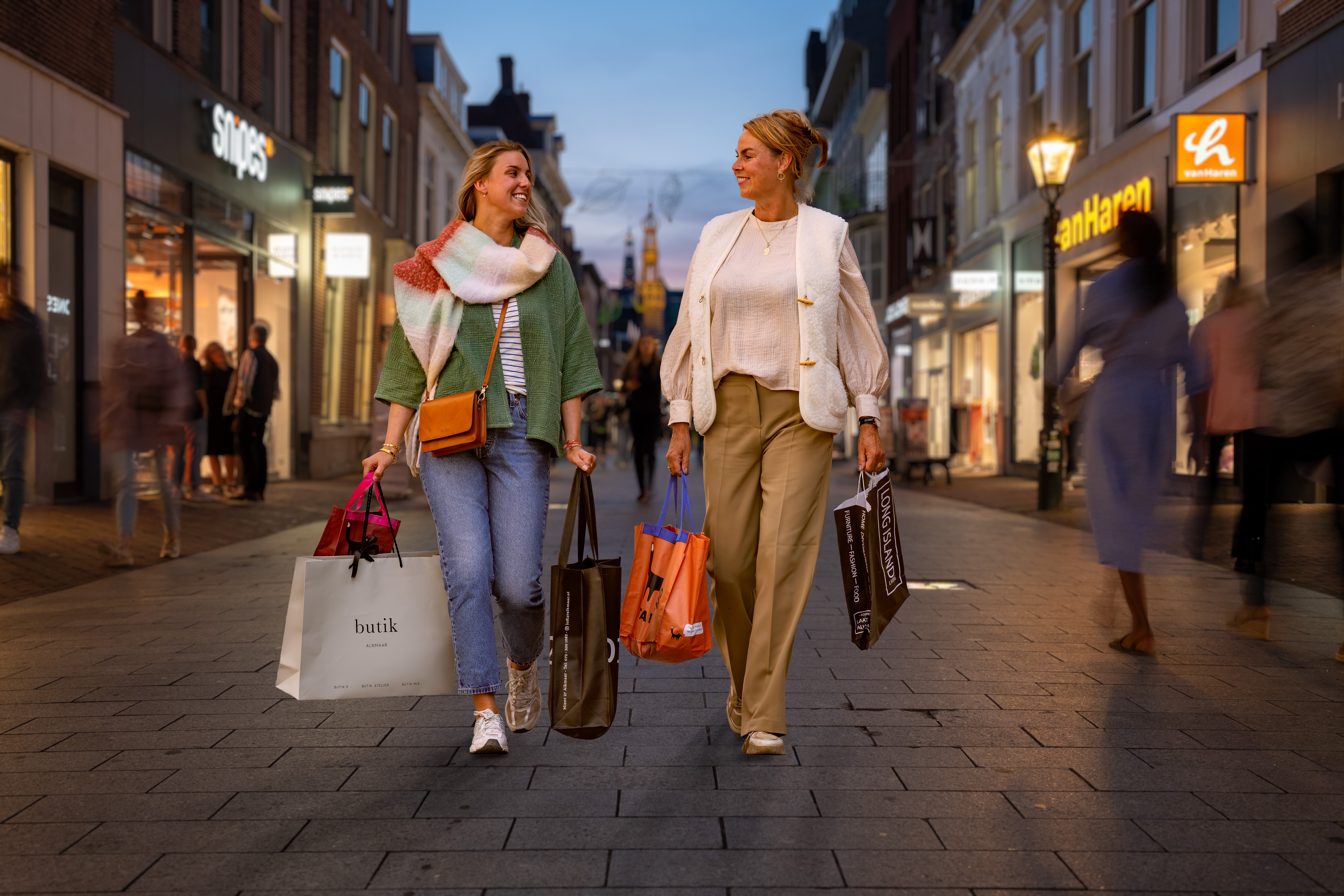Moeder en dochter winkelend in de Langestraat in de avond